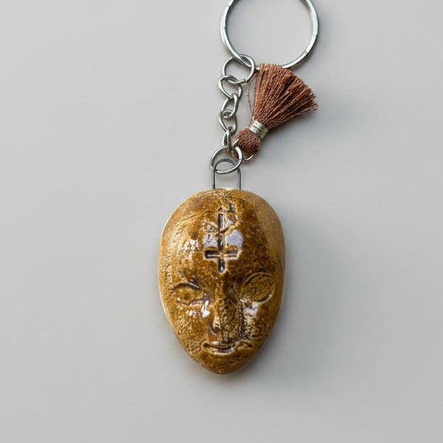 Doll Face Keyring – Enigmatic Ceramic Charm, 4 × 3 cm by Red Raven Pottery