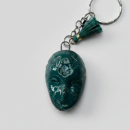 Doll Face Keyring – Enigmatic Ceramic Charm, 4 × 3 cm by Red Raven Pottery