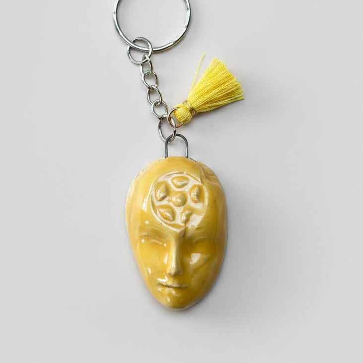 Doll Face Keyring – Enigmatic Ceramic Charm, 4 × 3 cm by Red Raven Pottery