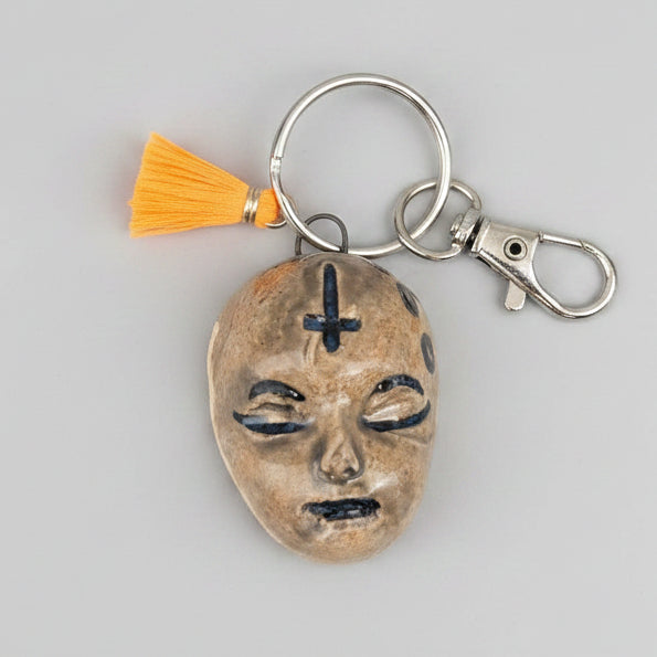 Doll Face Keyring – Enigmatic Ceramic Charm, 4 × 3 cm by Red Raven Pottery