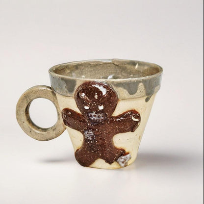 Frostbitten Gingerdead Ceramic Coffee Cup – Twisted Holiday Chaos, Ø9×8 cm by Red Raven Pottery