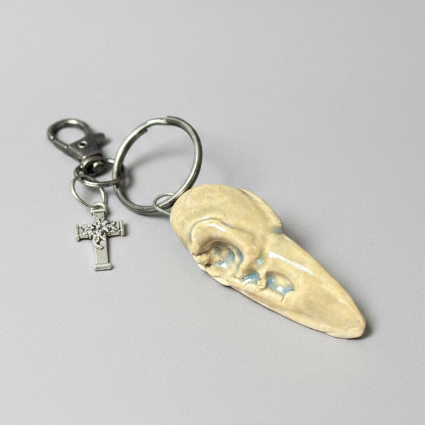 Raven Skull Ceramic Keychain – Charm of Death & Becoming, 5×2×1.5 cm by Red Raven Pottery