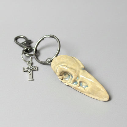 Raven Skull Ceramic Keychain – Charm of Death & Becoming, 5×2×1.5 cm by Red Raven Pottery